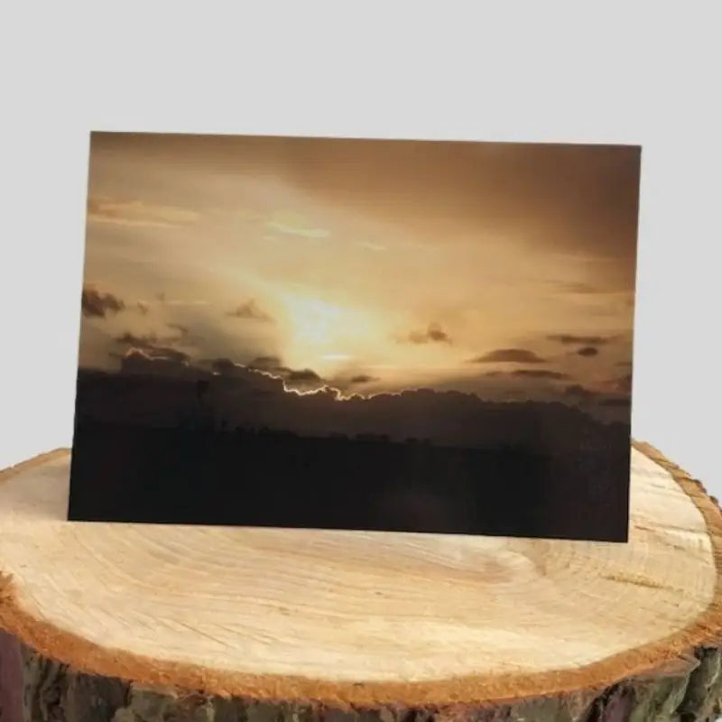 Golden Sunset Greetings Card on log